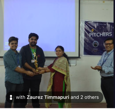 Vedant receiving the Pitch Perfect trophy